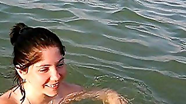 Naturally Busty Brunette Swimming Topless at the Beach