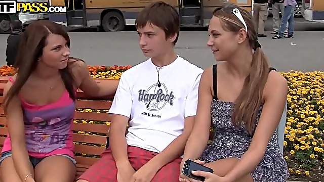 Two adorable chicks pleasing a guy in the park