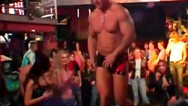 Orgy stripper dancing with excited girls at an orgy