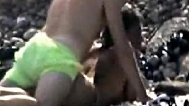 Woman gets her snatch pounded from behind on a beach