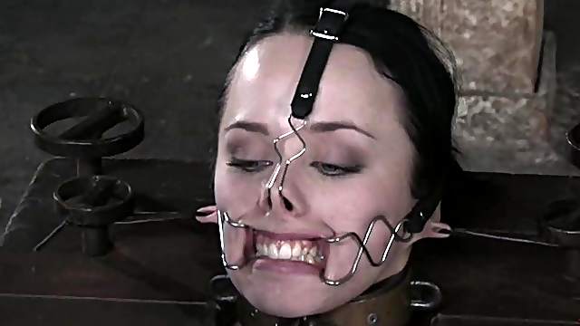 Two brunette girls get tied up to wooden posts and toyed
