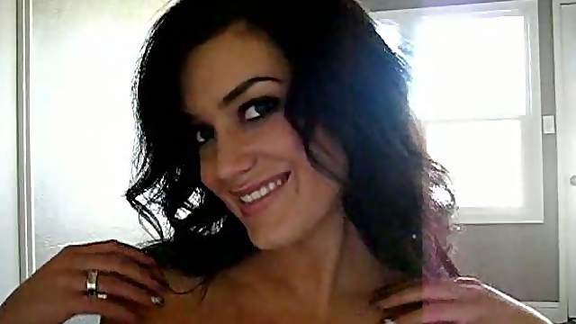 Long-haired brunette Carmen James strips slowly in front of a cam