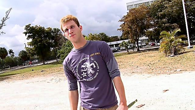Affectionate gay in t-shirt moaning while being given blowjob