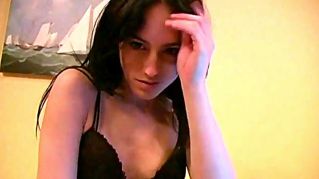 Charming solo model brunette with small tits unpinning her thong before fingering her pussy on a webcam