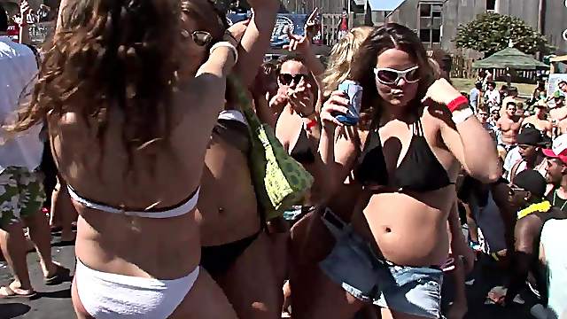 Sensual babes in bikinis and shorts with sexy bodies dancing at an outdoor party