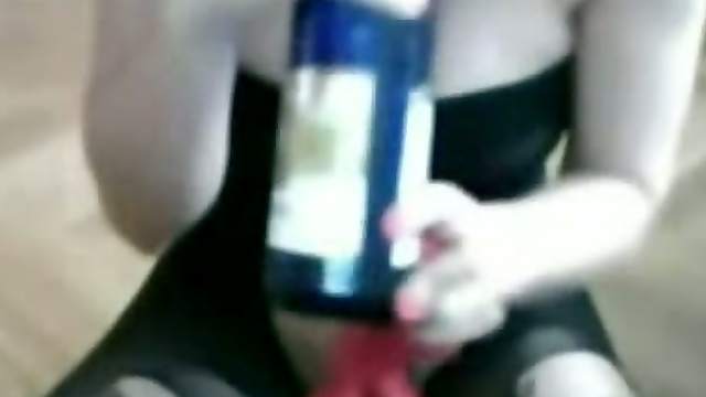 Busty amateur brunette uses a bottle to masturbate in homemade solo