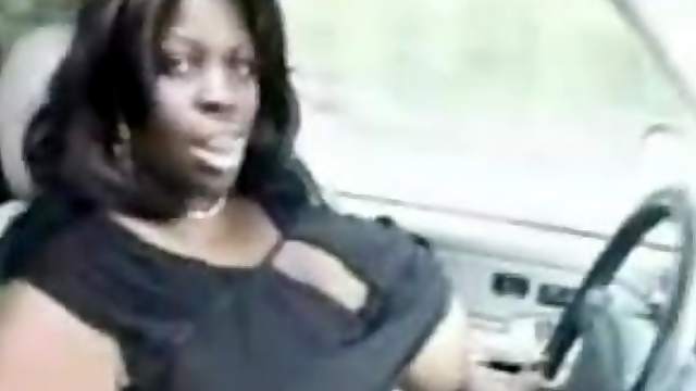 Amateur black slut shows her enormous natural tits in a car