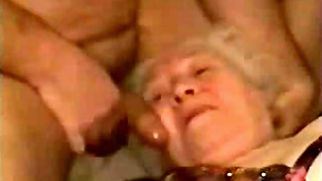 White-haired granny lets a guy rub his dick against her face