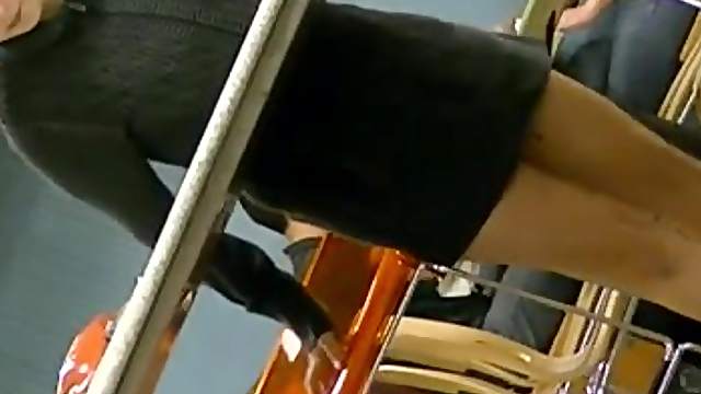 Slim chick wearing a miniskirt gets caught on voyeur's cam at a cafe