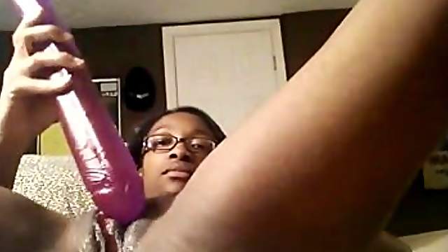 Ebony hussy in glasses smashes her vag with a toy in webcam solo scene