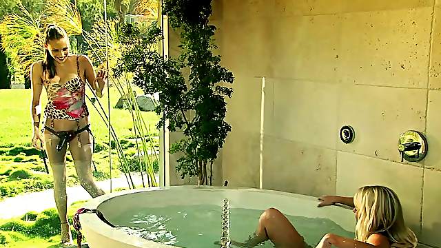 Glamorous lesbian babe getting drilled with a strap on dildo in a bath tub