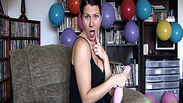Hot woman blows air in balloon to grow bigger