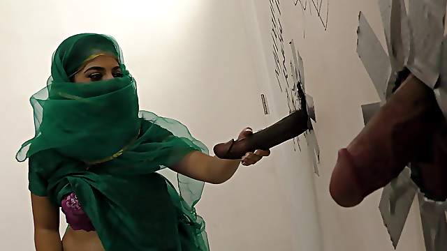 Muslim bitch sucking cocks at a gloryhole and receives a facial