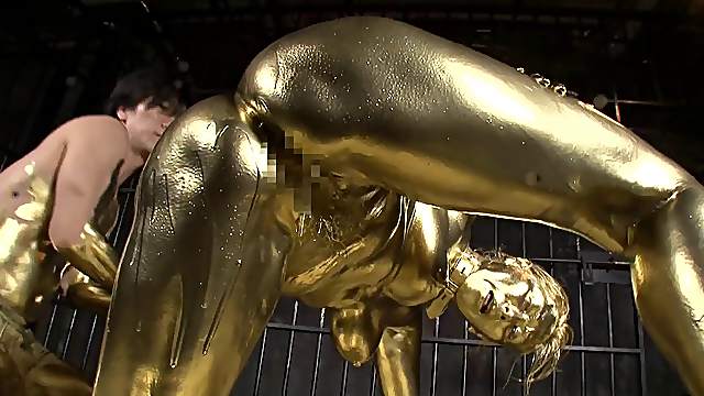 She is covered in gold paint then she gets fucked by a golden guy