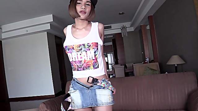 Young Thai t-girl Benty takes off her denim miniskirt