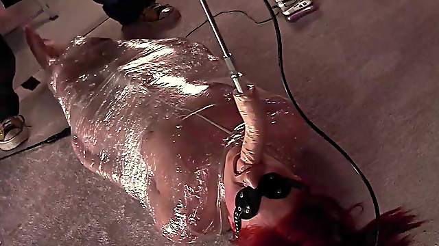 Redhead submissive MILF babe is wrapped in foil and face fucked