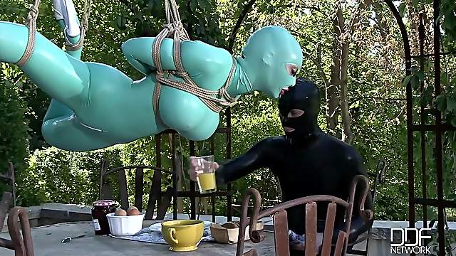 costumed Latex Lucy enjoys kinky sex games with a guy while she hangs