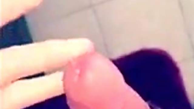 Young amateur tugs a dick in the bathroom in front of the mirror