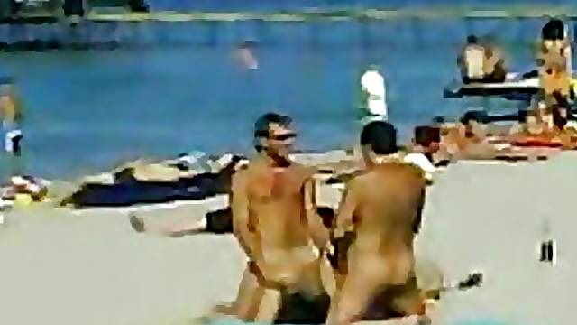Two Guys and One Sexy Babe Have a Hot Threesome on a Nude Beach