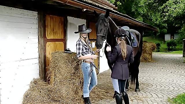 Two beautiful chicks play lesbian games on the stable