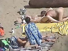 Girl gets her pussy fingered by her husband on a nude beach