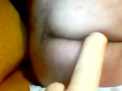 Hussy with ugly butt fucks her twat with a dildo in homemade solo