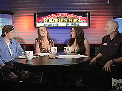 Chubby porn star with long dark hair laughing and chatting backstage