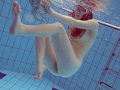 Solo model with the red hair decides to get naked under the water