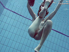 Slender raven-haired stunner undresses while diving in the pool