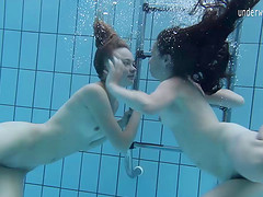 Two lovely babes enjoy making out passionately under the water