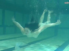 Sensual raven-haired looker unveils her curvy body under the water