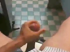 Some fella jerking off in a cubicle