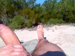 He's jerking off on the beach